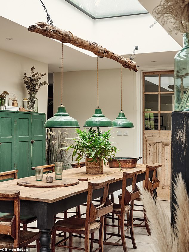 Industrial-style pendant lights over the table will create a talking point. Here they are suspended from a piece of salvaged driftwood