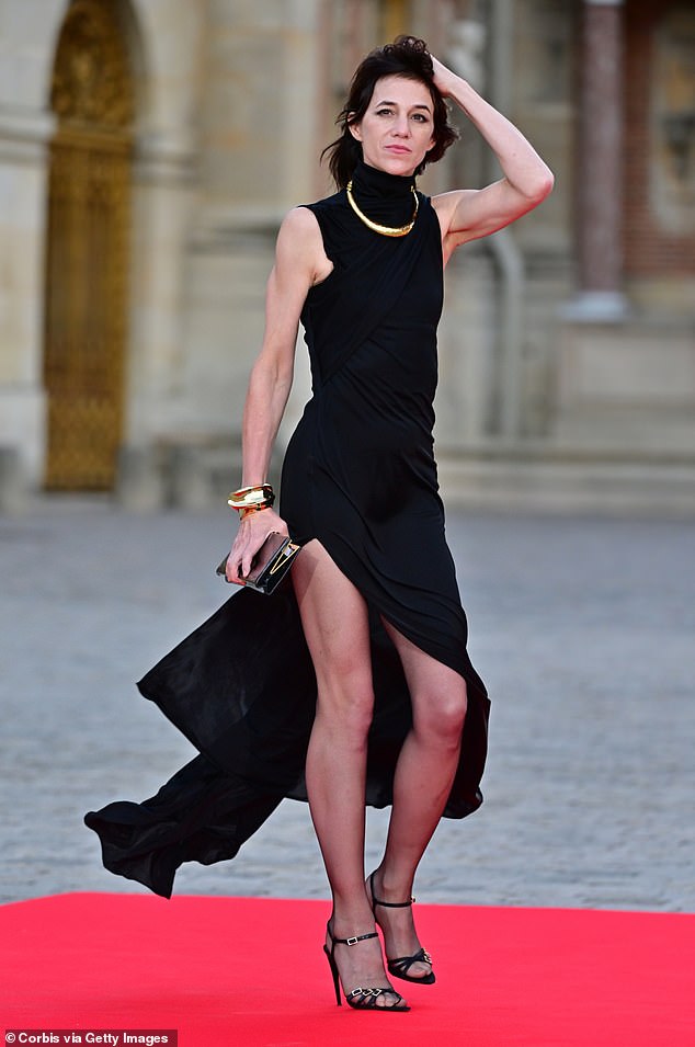 Charlotte Gainsbourg paired her evening dress with black sheers at the Palace of Versailles last month