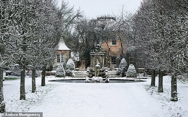 In the snowy grounds of a Hampshire mansion, a statue of Pan plays pipes in an ornamental pool, framed by an avenue of limes