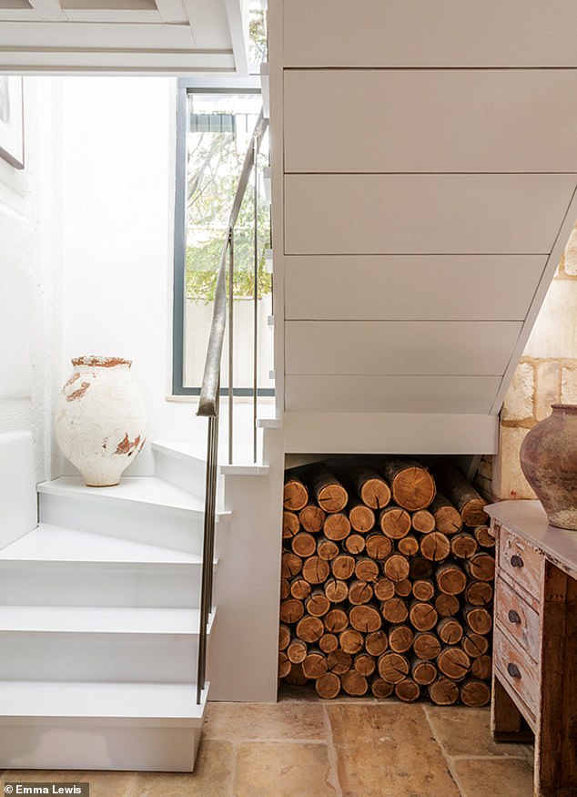 A staircase leads up to the master suite in a new extension connected to the original cottage. For a range of decorative vessels try antonandk.co.uk