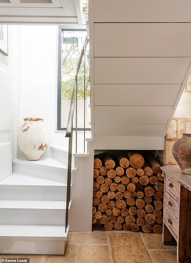 A staircase leads up to the master suite in a new extension connected to the original cottage. For a range of decorative vessels try antonandk.co.uk